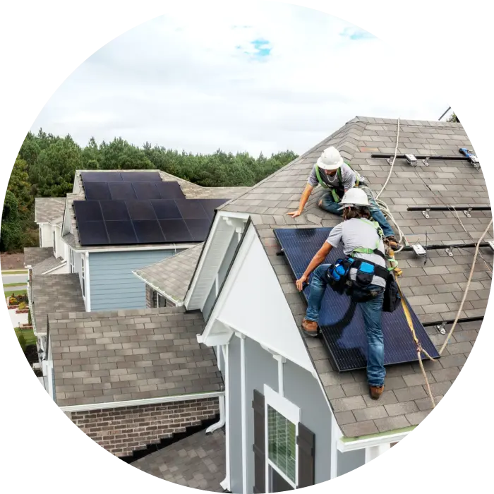 Solar installers installing Qcells panels on a residential roof
